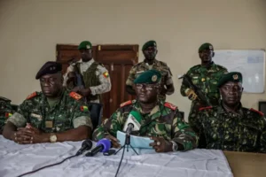 Brigadier General Denis N'Canha, head of the military office of the Guinea-Bissau presidency, announces the government takeover on November 26, 2025 [Patrick Meinhardt/AFP]